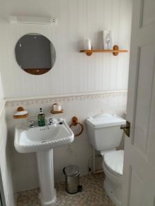 a bathroom with a sink and a toilet and a mirror at Kingscliff in Blackpool