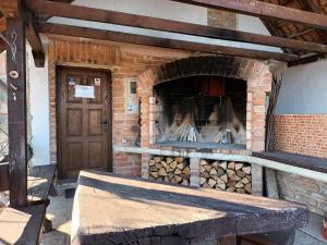 a brick oven with a pile of fire wood at Robinson Vila Kitokret in Kutjevo