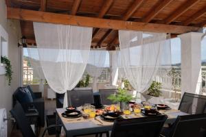 a dining room with a table with food on it at Villa Aelia in Magouládes