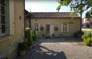 a house with a courtyard in front of it at Les Bouges in Salles