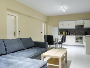 a living room with a couch and a table at Apartment Lazarous 1 in Apolakkiá