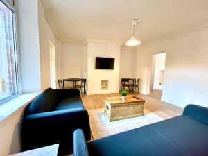 a living room with a couch and a coffee table at Huge serviced Apartment with FREE PARKING in Jesmond