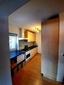 a kitchen with white cabinets and a black counter top at Chalet Dobratsch in Latschach