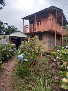 a house with a balcony on top of a yard at Finca Fuente de Vida in Estelí