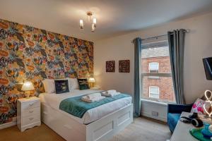 a bedroom with a bed and a large window at *NEW* Chester Canal Side 2 bed character home in Chester