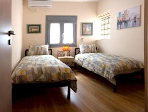 a bedroom with two beds and a window at Αcacia House - Fully Equipped Apartment in Glyfada in Athens