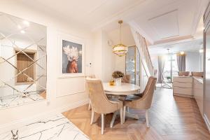 a dining room with a table and chairs at Gold Apartment Szczecinek in Szczecinek