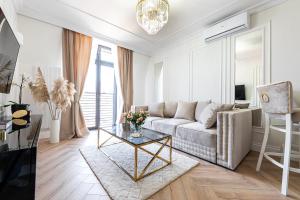 a living room with a couch and a table at Gold Apartment Szczecinek in Szczecinek