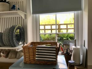 een mand op een tafel naast een raam bij The Bothy - your unique luxury refuge in Saint Fillans