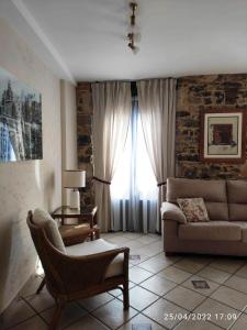 a living room with a couch and a window at Apartamento Campomanes in Villaviciosa