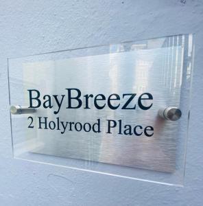 a sign on a door that reads bay breeze hollywood place at BayBreeze Apartment The Hoe in Plymouth