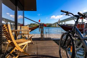 a bike parked on a dock next to a boat at Oporto Douro Floating House in Porto