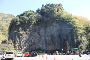 a large mountain with cars parked on a road at Minpaku Taki - Vacation STAY 12843 in Gero