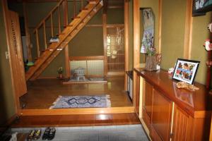 a hallway with a staircase and a living room at Minpaku Taki - Vacation STAY 12840 in Gero