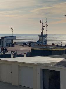 a beach with people walking on the sand and the ocean at Petite escapade à la Picardière in Fort-Mahon-Plage +10 photos