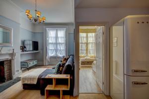 a living room with a bed and a fireplace at NEW Grade 2 historic flat in the heart of Chester in Chester