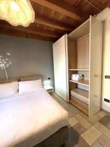 Un dormitorio con una gran cama blanca y una lámpara de araña. en Appartamento San Martino, en Verona