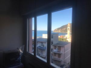 a window with a view of the ocean from a building at Vista mare 6 minuti a piedi dalla spiaggia, box. in Moneglia