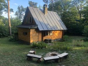 a small brick house with a black roof at Wooden house in the nature in Modra