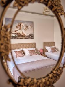 a mirror reflection of a bedroom with two beds at Athina Studios in Laganas