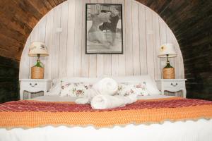 a bedroom with a bed with a towel on it at Hotel La Calma De Rita - Pirque in Pirque