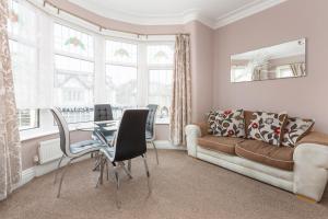 a living room with a couch and a table at Beachcliffe Holiday Apartments in Blackpool