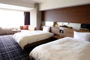 Postel nebo postele na pokoji v ubytování Kofu Kinenbi Hotel