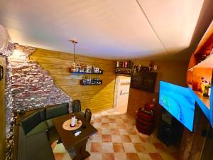 a room with a table and a tv in a room at Villa Mostar - Resort Rozic in Mostar