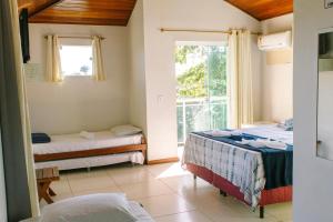 a room with two beds and a window at L´Grace Geriba in Búzios +37 photos