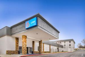 a building with a gas station sign on it at Studio 6 Bartlesville - OK in Bartlesville