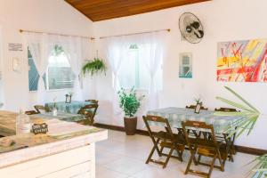 a dining room with two tables and chairs at L´Grace Geriba in Búzios