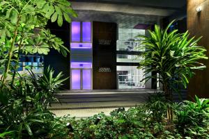 a building with purple and purple lights on it at YOTEL Singapore Orchard Road in Singapore