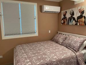 a small bedroom with a bed and a window at Palmas View Premium 5 in Candelero Arriba