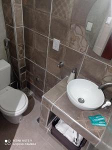 a bathroom with a sink and a toilet at Mágnum Apartments Studio in Mendoza