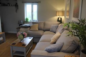 a living room with a couch and a table at Cheviots Cottage in Totnes