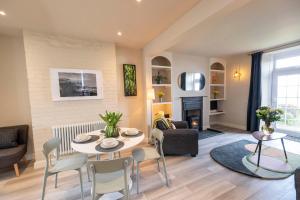 a living room with a table and chairs at Harbour View Cottage in Watchet
