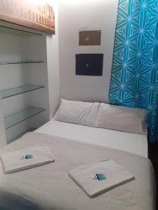 a bedroom with a bed with two towels on it at Happy Rome in Rome +19 photos