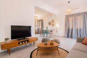 a living room with a large flat screen tv at Casa il Fiume in Alykes