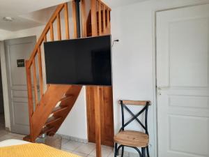 a flat screen tv on a wall in a room at RESIDENCE KER OSMOZ in Saint-Herblain