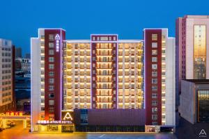 a large building with lights on in a city at Atour Hotel Jincheng Development Lanhua Road in Jingcheng