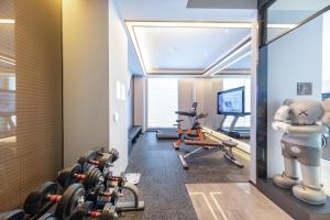 a gym with dumbbells and a dummy in a room at Atour Hotel Jincheng Development Lanhua Road in Jingcheng