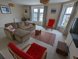 布德的住宿－Sea Horizon View，带沙发和红色椅子的客厅