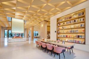 a dining room with a table and chairs and a fireplace at Atour Hotel Hengyang South Mountain Hengshan Scenic Area in Nanyue