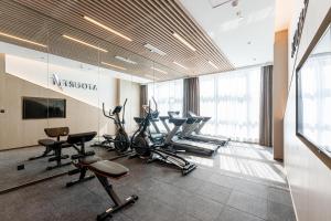 a gym with treadmills and exercise equipment in a building at Atour Hotel Yiwu International Trade Transportation Center in Yiwu