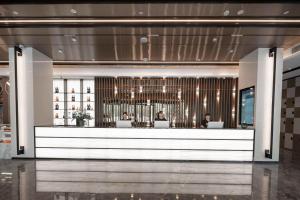 a lobby with people sitting at a bar at Atour Light Hotel Nanjing Agricultural University in Nanjing