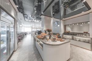a restaurant with a counter with food on it at Atour Light Hotel Nantong Drum Plaza South Street in Nantong