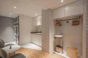 a kitchen with white cabinets and a white table at Atour Hotel Taizhou Maoye World in Taizhou