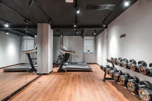 a gym with rows of exercise equipment and wooden floors at Atour Light Hotel Nantong West Youth Road in Nantong