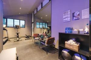 a hair salon with chairs and a purple wall at Atour S Hotel Wuxi Nanchang Street in Wuxi