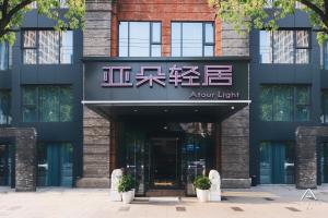 a front view of a building with an arrow light sign at Atour Light Hotel Nantong West Youth Road in Nantong